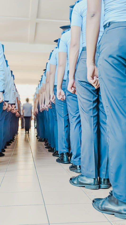 a group of people standing in a line with their hands in their pockets