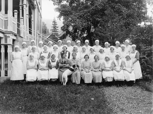 Group of women and a dog posing outdoors