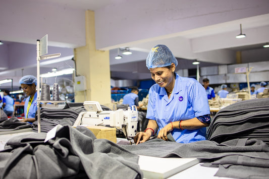 Workers sew clothes in a factory.